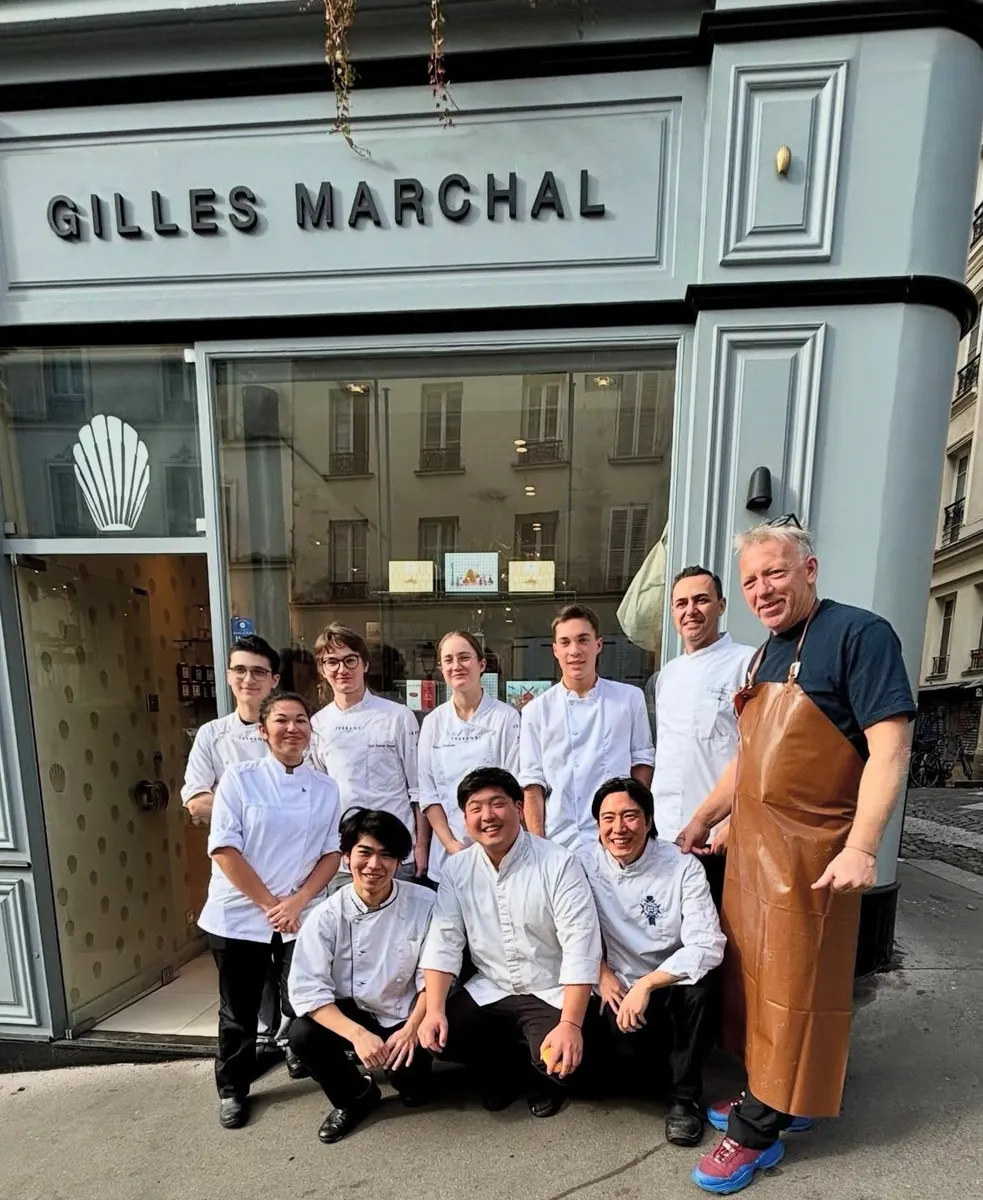 Ali Al Ghoul (back row, white chef coat) at the Gilles Marchal patisserie in Paris with Gilles Marchal (right, leather apron) and the team.