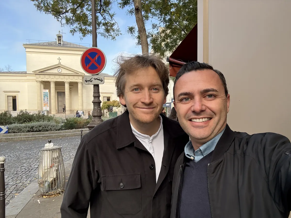 Ali Al Ghoul with a fellow Paris pastry chef on a Right Bank street, with a haussmann-era church visible in the background.