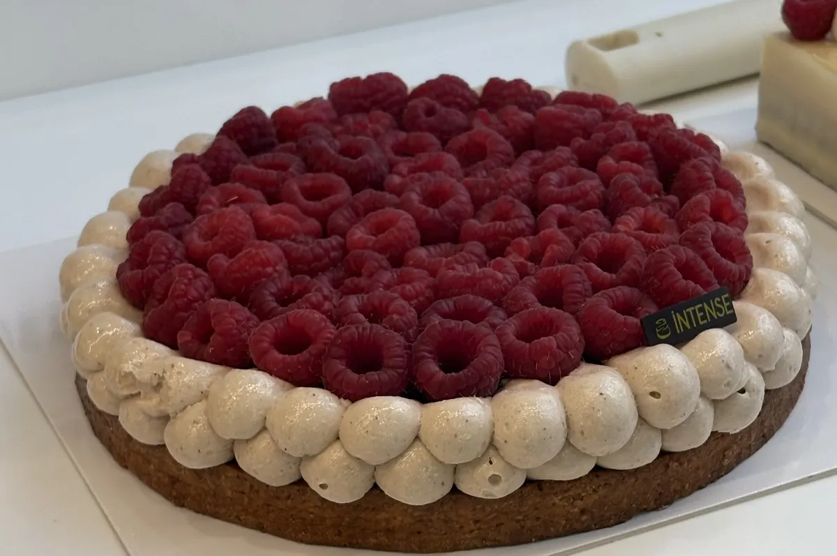 Ali's raspberry tart — fresh raspberries piled on a sablé crust, surrounded by piped chestnut cream rosettes.
